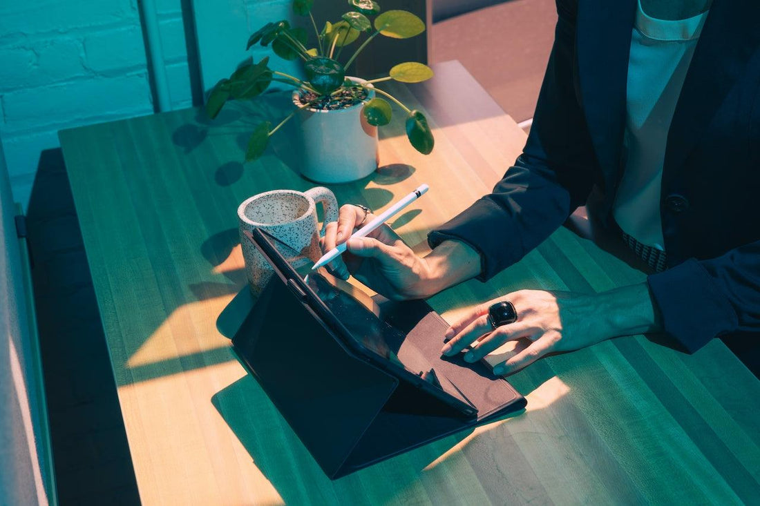 A woman's hands are shown typing on a tablet keyboard.